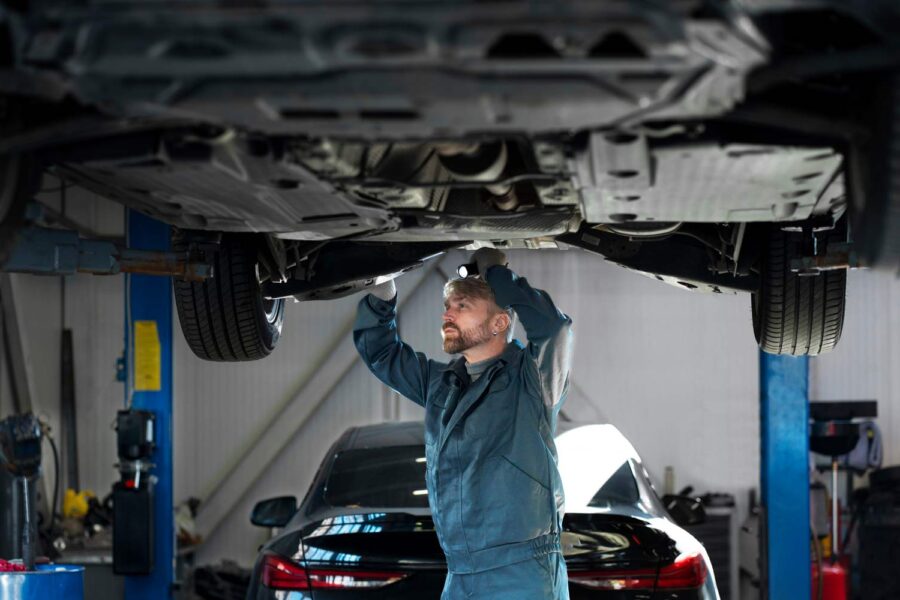 tecnico revisando bajos del vehiculo
